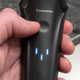 The Arc6's power button being used to put it into cleaning mode.